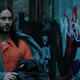 Michael Morbius passing by an image of Spider-Man.